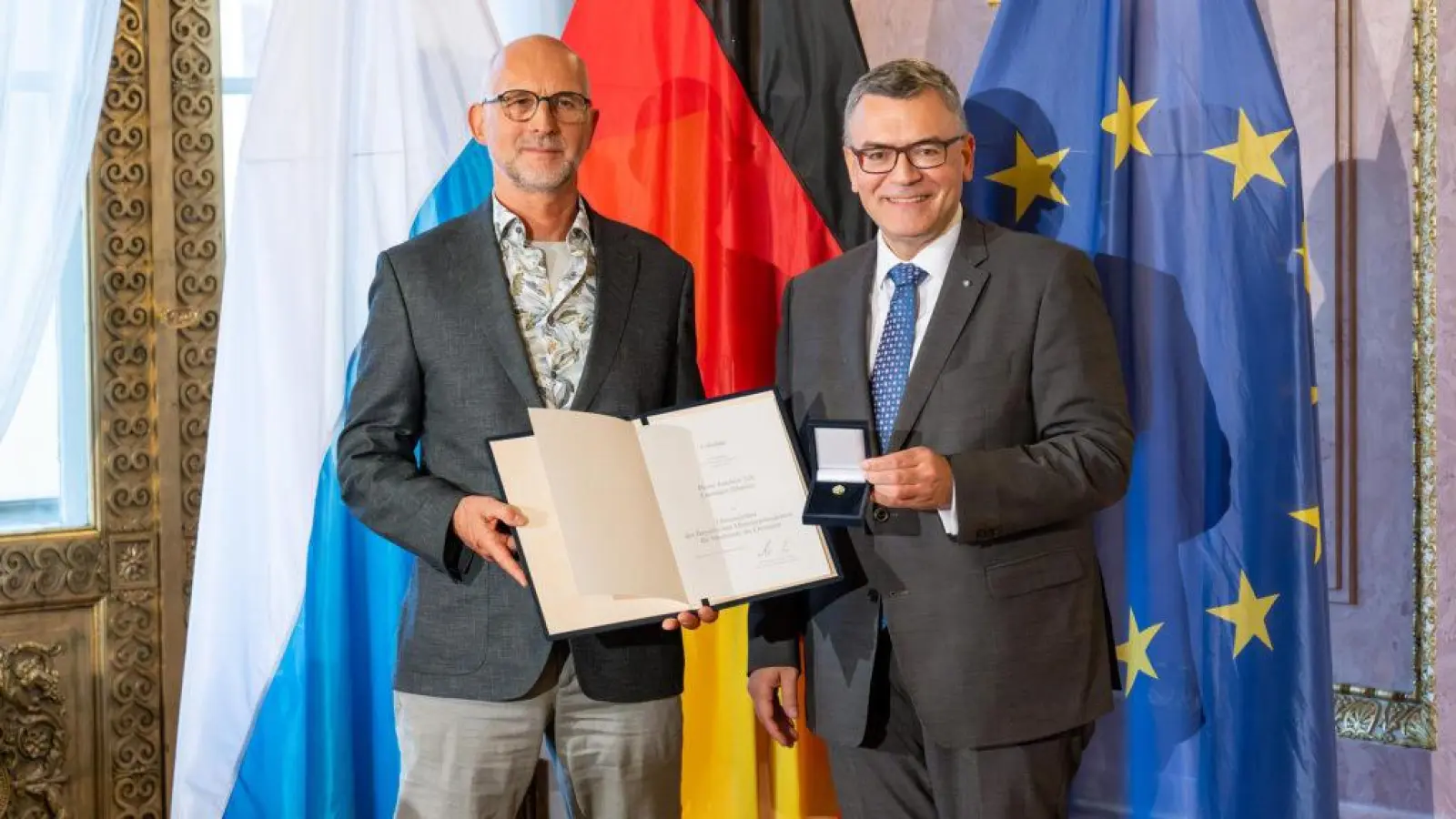 Joachim Veh und Staatskanzleichef Dr. Florian Herrmann (v. l.) bei der Übergabe des Ehrenzeichens. (Foto: Bayerische Staatskanzlei)